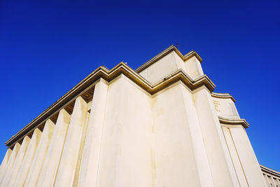 Low angle view of building against clear blue sky