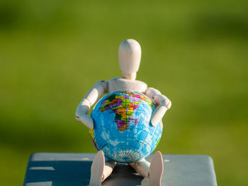 Close-up of figurine with globe