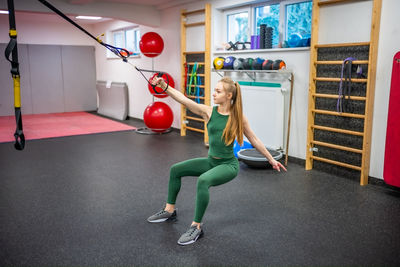 Low section of woman exercising in gym