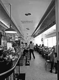View of woman standing on tiled floor