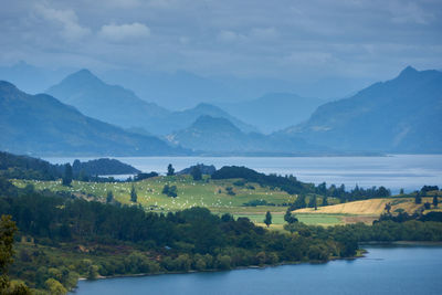 Scenic view of lake and mountains against sky