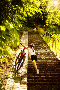 People riding bicycle on footpath