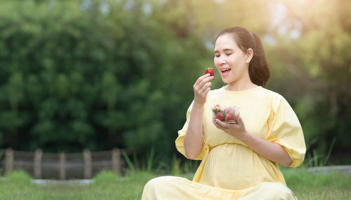 Young woman sitting on field