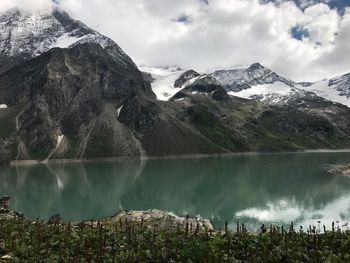 Scenic view of lake and mountains against sky