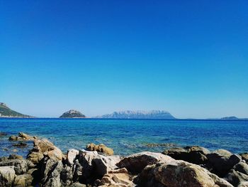 View of calm sea against clear blue sky