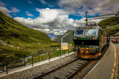 Train on railroad track against sky