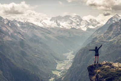 Rear view of man standing on mountain