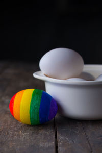 Close-up of multi colored eggs in bowl on table