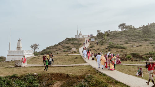 Hindu jain pilgrims people walking toward shikharji temple. parasnath, giridih, jharkhand