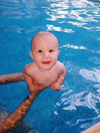 High angle view of boy swimming in pool