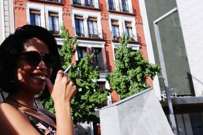 Young woman using mobile phone in city