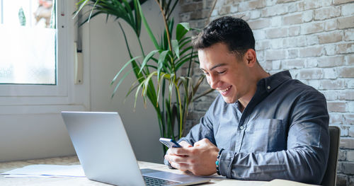 Young man using laptop at office