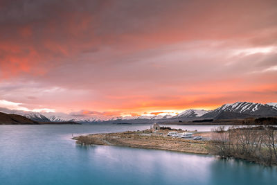 Sunrise view of the church of good shepherd with beautiful snow capped mountain range. 