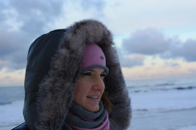 Portrait of smiling young woman in warm clothing