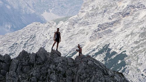 Man standing on rock by mountains