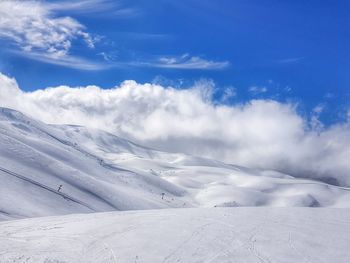 Scenic view of snowcapped mountains against sky