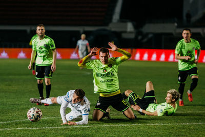 People playing soccer on field