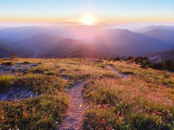 Scenic view of mountains against sky during sunset