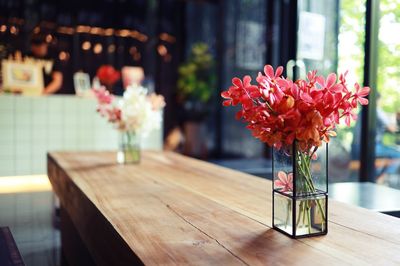 Close-up of red flower vase on table