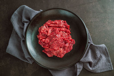 High angle view of red meat on table