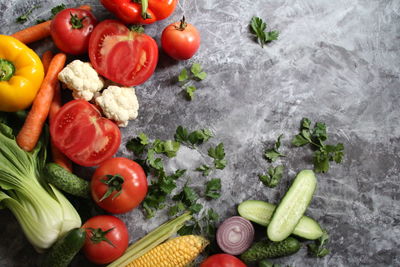 Tomatoes and vegetables on cutting board