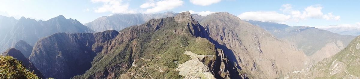 Panoramic view of mountains against cloudy sky