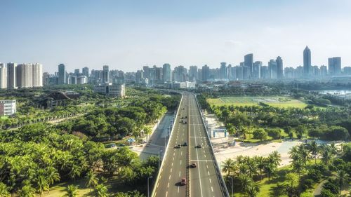 Panoramic view of road amidst buildings in city against sky