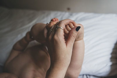 Close-up of woman lying on bed