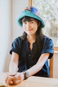 Portrait of a smiling girl sitting on table