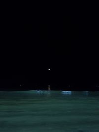 Scenic view of sea against clear sky at night