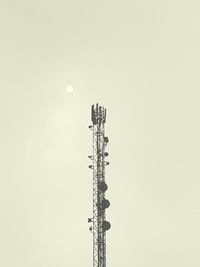 Low angle view of communications tower against sky