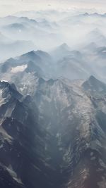 High angle view of snowcapped mountains against sky