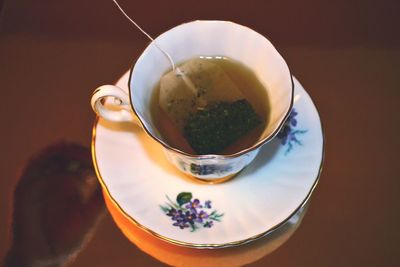 Close-up of herbal tea with tea bag on table