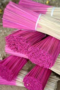 Close-up of pink scent sticks on table