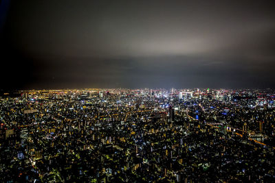 High angle view of city lit up at night