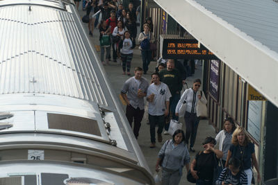 High angle view of people walking on road in city