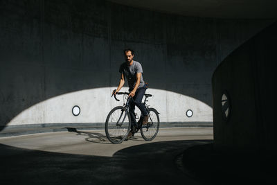 Man riding bicycle on bridge