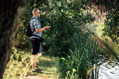 Fisherman with spinning rod on the summer lake. fisherman with spinning in his hands catching fish