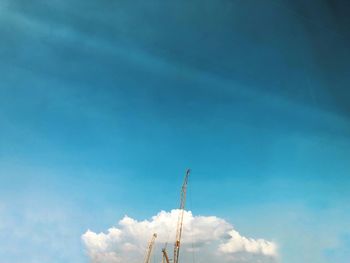 Low angle view of vapor trail against blue sky