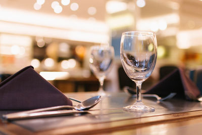 Close-up of wine glasses on table in restaurant