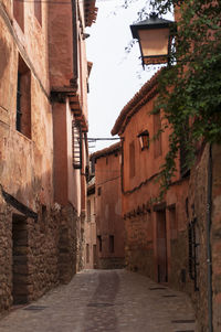 Alley amidst buildings against sky