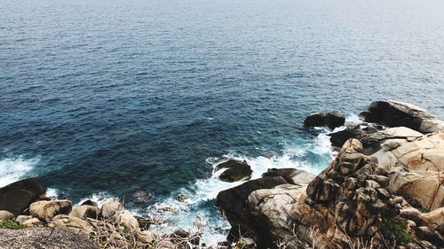 High angle view of rocks in sea