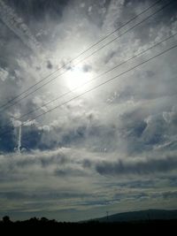 Silhouette landscape against cloudy sky