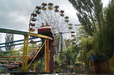 Low angle view of ferris wheel against sky