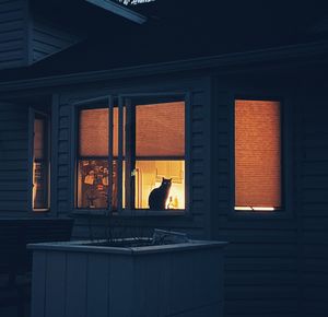 Man and woman seen through glass window of building