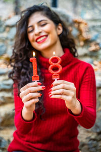 Portrait of a smiling young woman holding ice cream