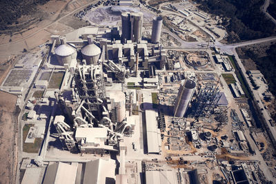 Huge cement producing plant. aerial view of silos towers, pipes and structures of industrial area