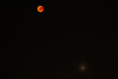 Low angle view of moon against sky at night