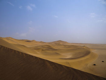 Photograph of a sand dune in the namib desert near swakopmund, namibia on a sunny dry season morning