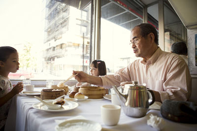 Side view of man preparing food at home